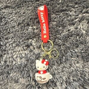 Fun Cute Hello Kitty Keychain with Red Strap Featuring Yellow & Gold Accents